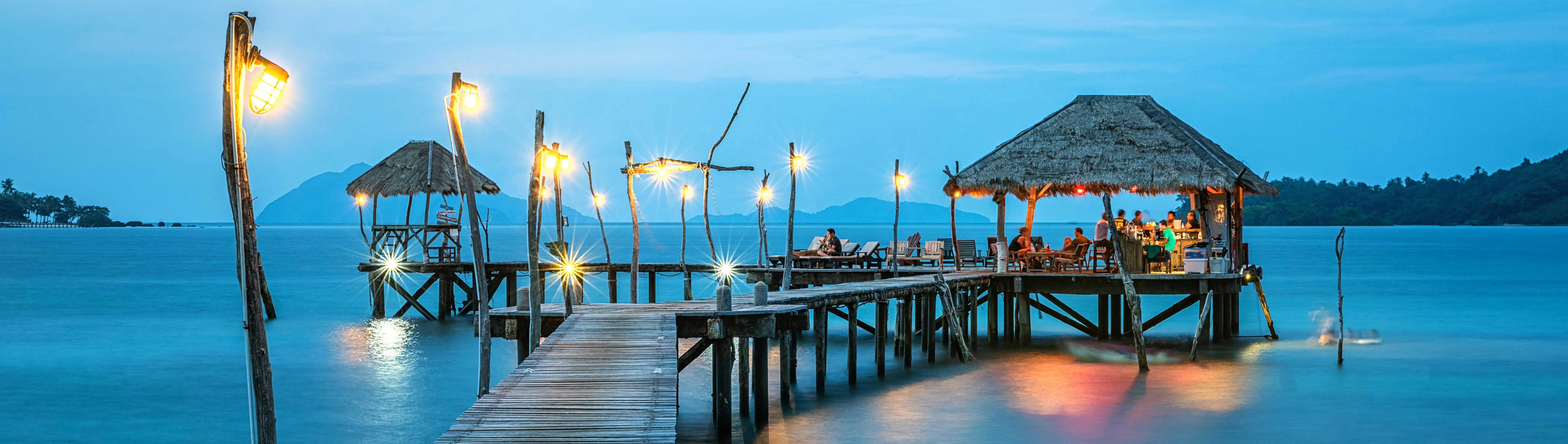 People hanging out in a dock above the water